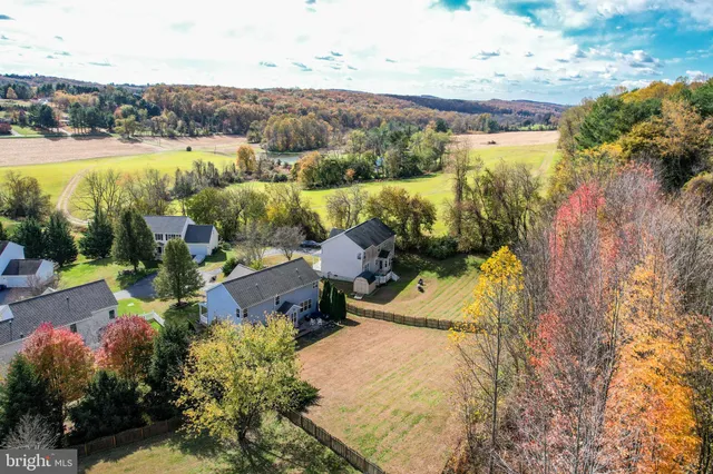 an aerial view of a houses with yard