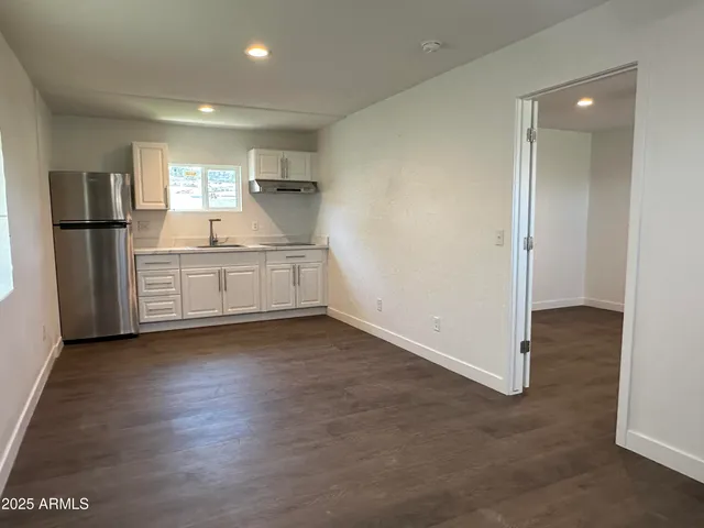 a kitchen with stainless steel appliances granite countertop a refrigerator and a sink