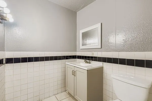 a bathroom with a sink a toilet and a mirror