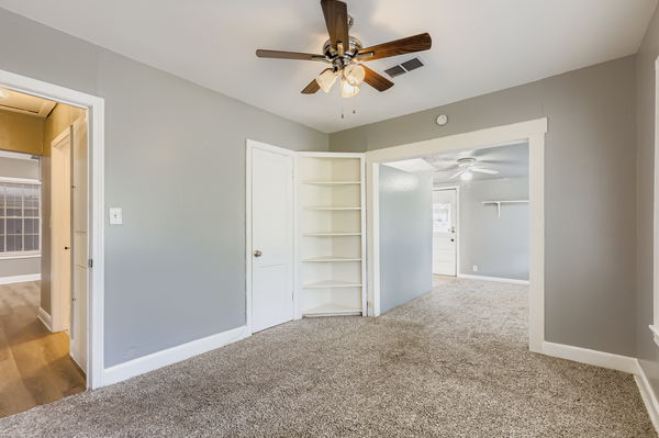 700 West St Johns Avenue Austin, TX 78752 - Photo 10 of 16 a view of a big room with closet and a ceiling fan