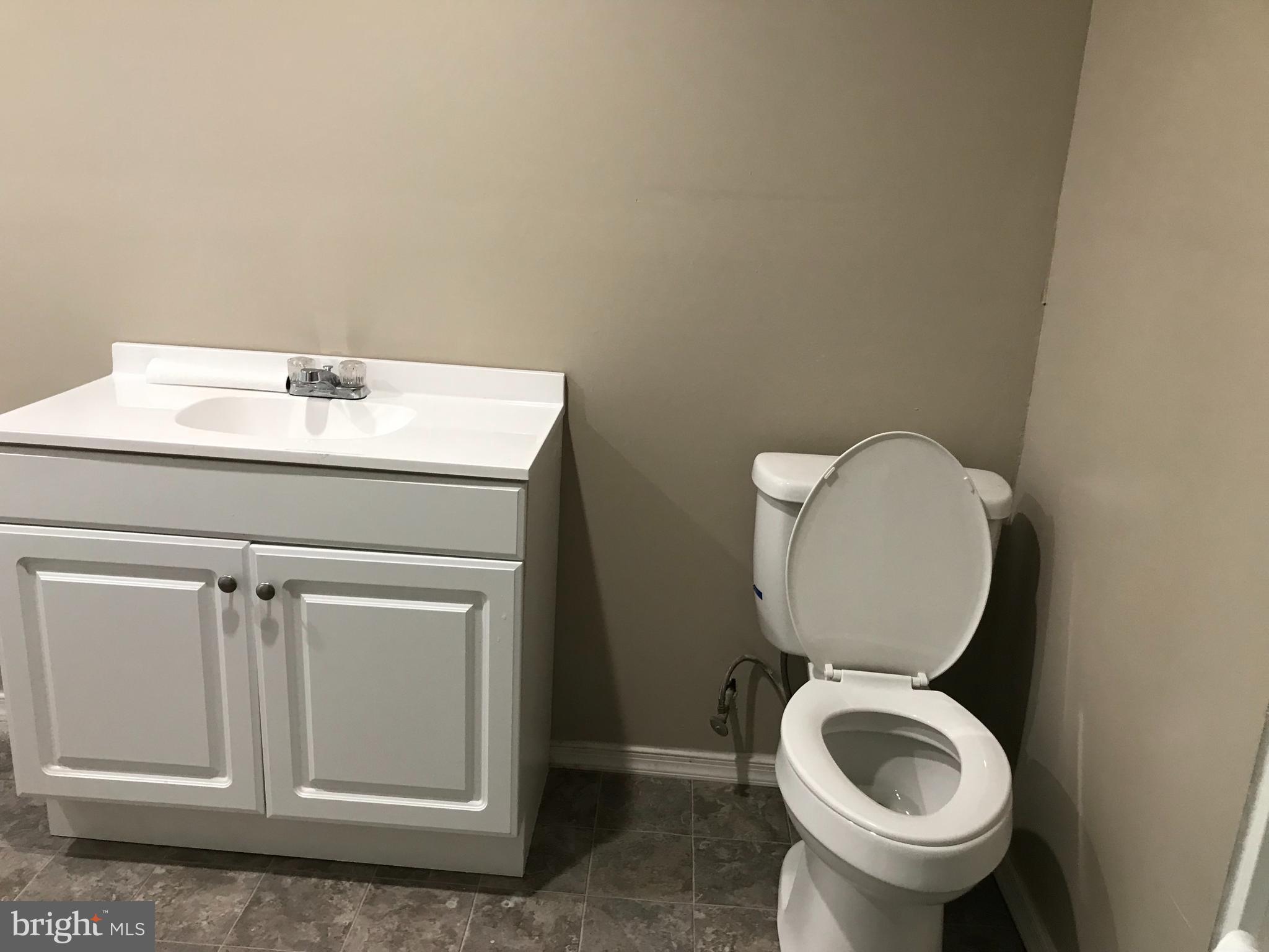 1626 Mineral Spring Road Reading, PA 19602 - Photo 16 of 20 a bathroom with a toilet sink and mirror