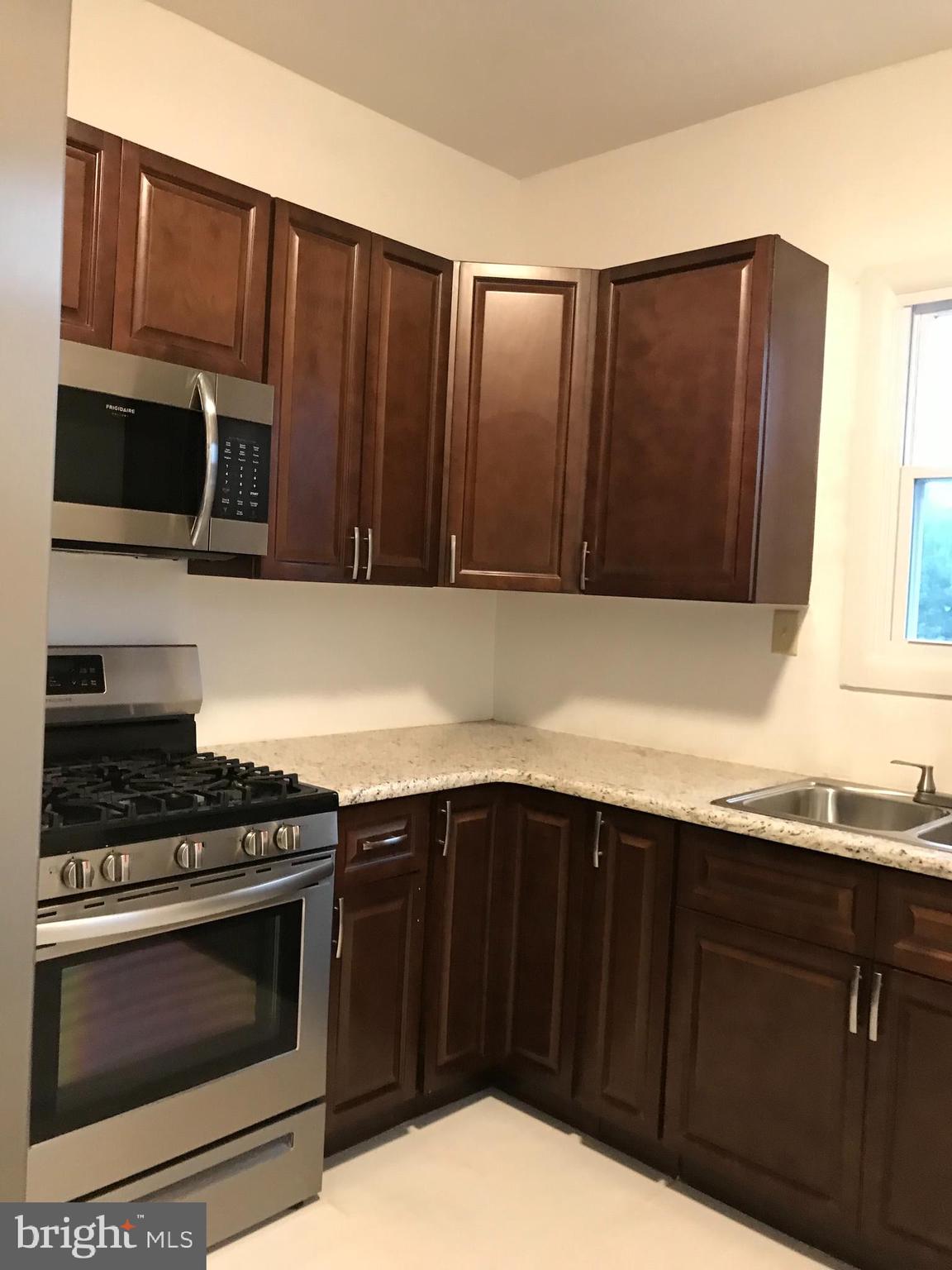 1626 Mineral Spring Road Reading, PA 19602 - Photo 6 of 20 a kitchen with granite countertop wooden cabinets and stainless steel appliances
