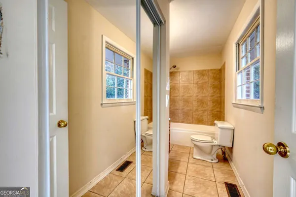 a bathroom with a window and a shower