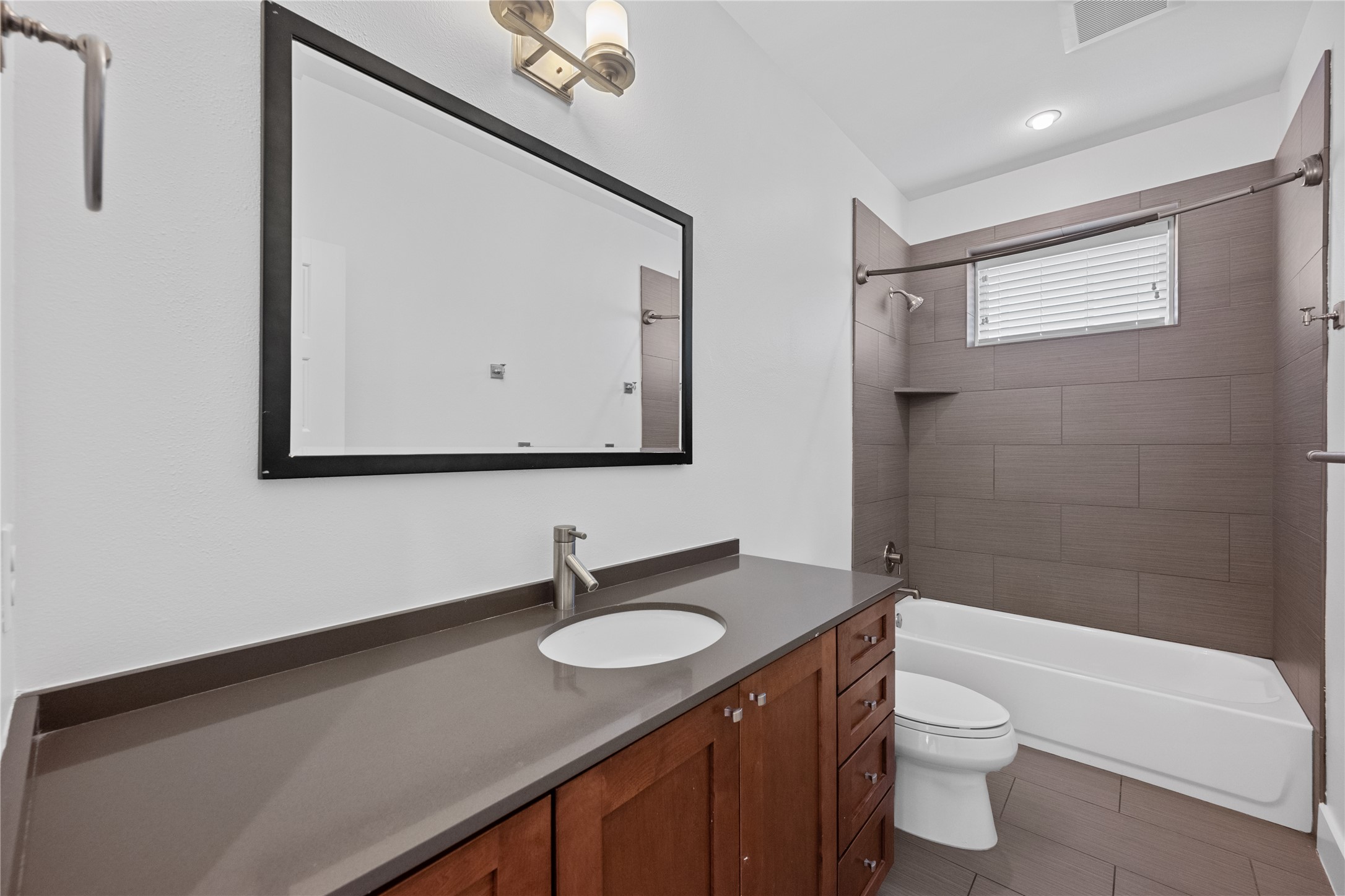 1303 Azie Morton Road, Unit 3 Austin, TX 78704 - Photo 13 of 24 a bathroom with a granite countertop sink toilet and mirror