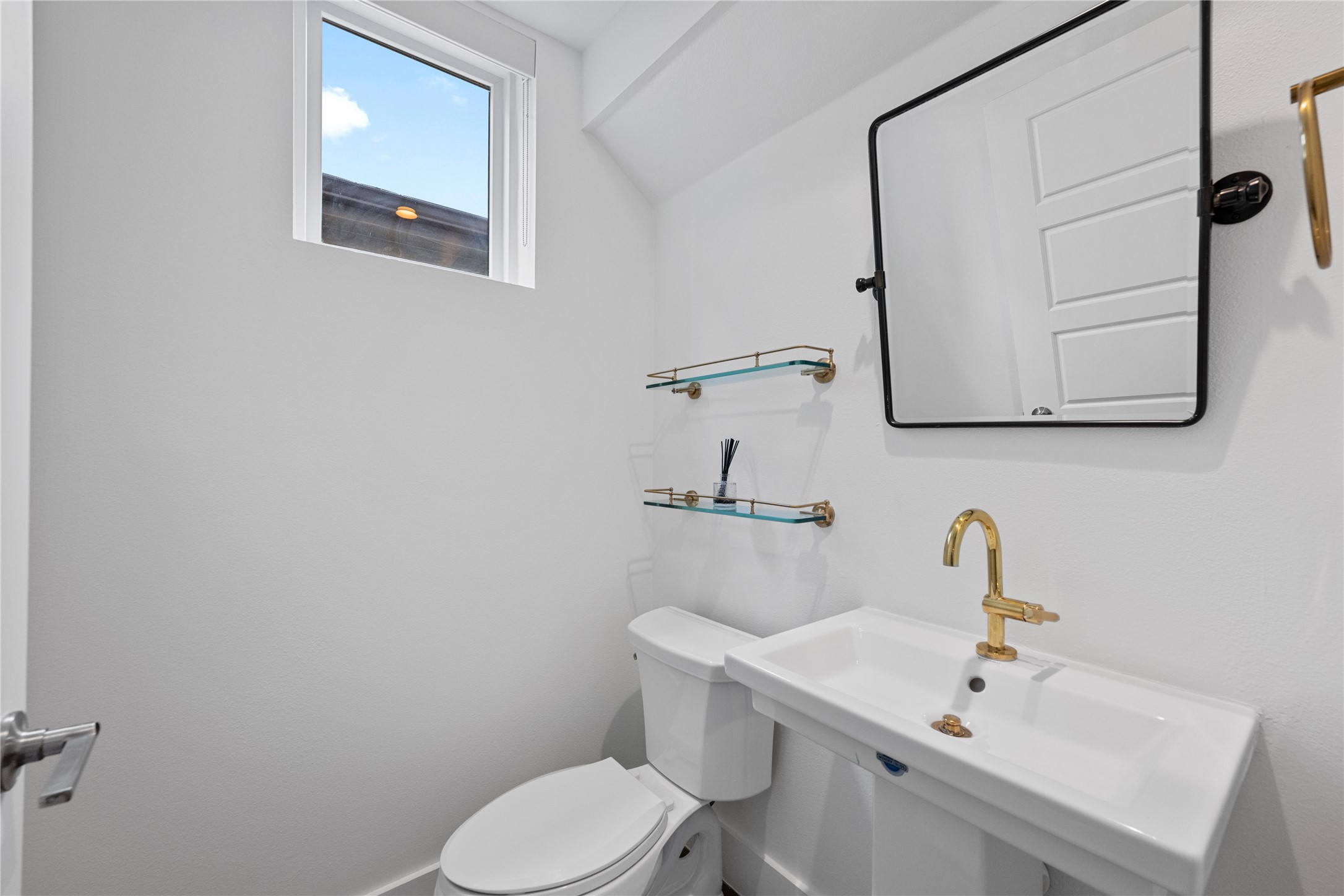 1303 Azie Morton Road, Unit 3 Austin, TX 78704 - Photo 15 of 24 a bathroom with a toilet sink and mirror