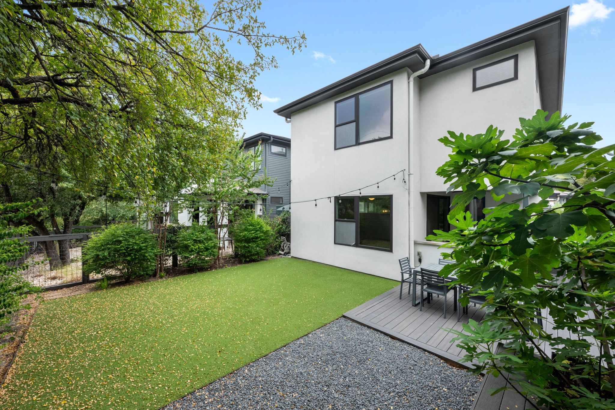 1303 Azie Morton Road, Unit 3 Austin, TX 78704 - Photo 19 of 24 a white house with a small yard and a large tree