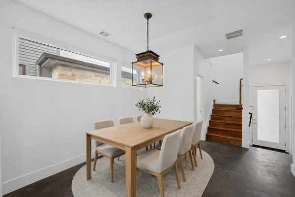 a dining room with furniture and wooden floor