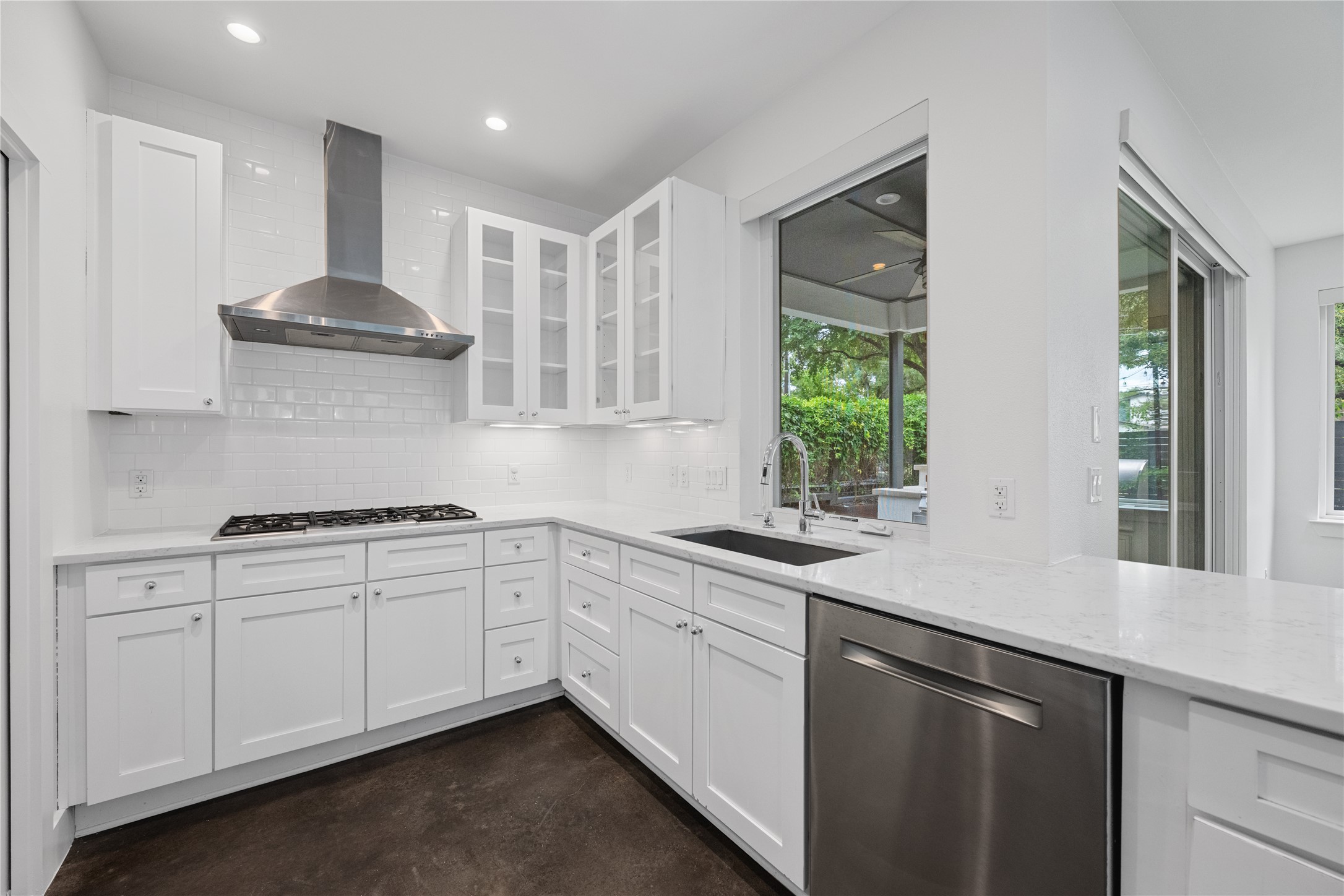 1303 Azie Morton Road, Unit 3 Austin, TX 78704 - Photo 5 of 24 a kitchen with granite countertop white cabinets and a stove