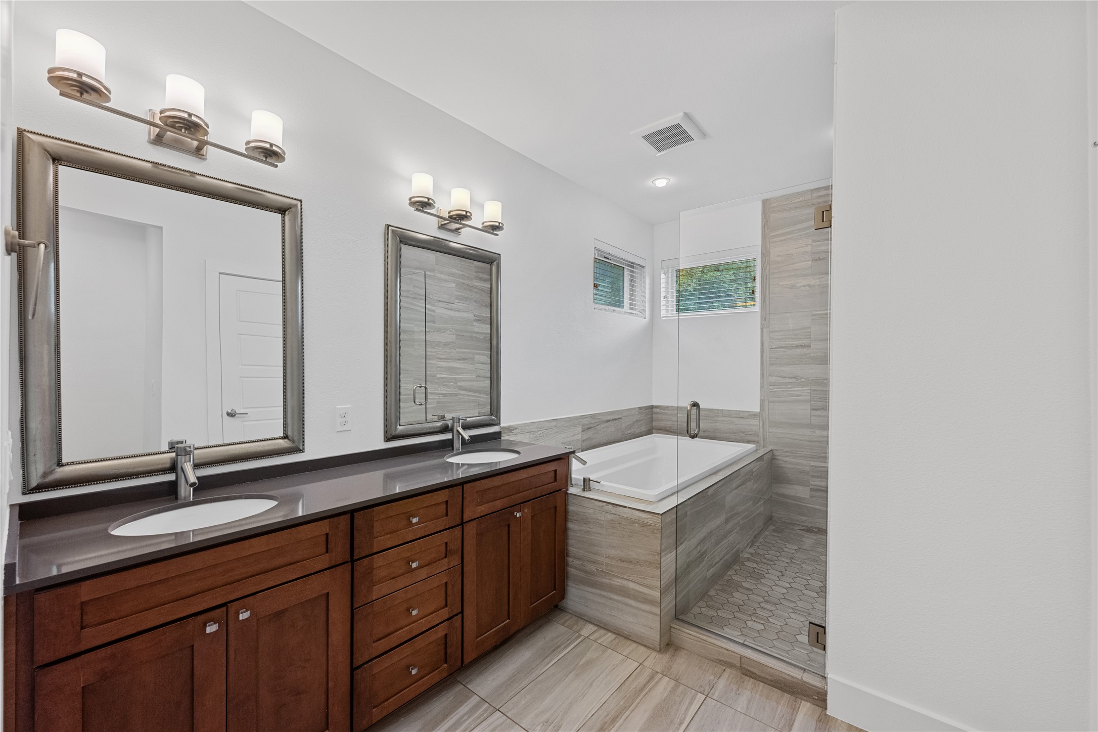 1303 Azie Morton Road, Unit 3 Austin, TX 78704 - Photo 7 of 24 a bathroom with a sink double vanity granite tub and a mirror
