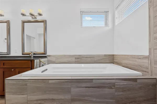 a bathroom with a bathtub and a sink