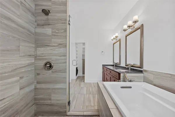 a bathroom with a double vanity sink a mirror and shower