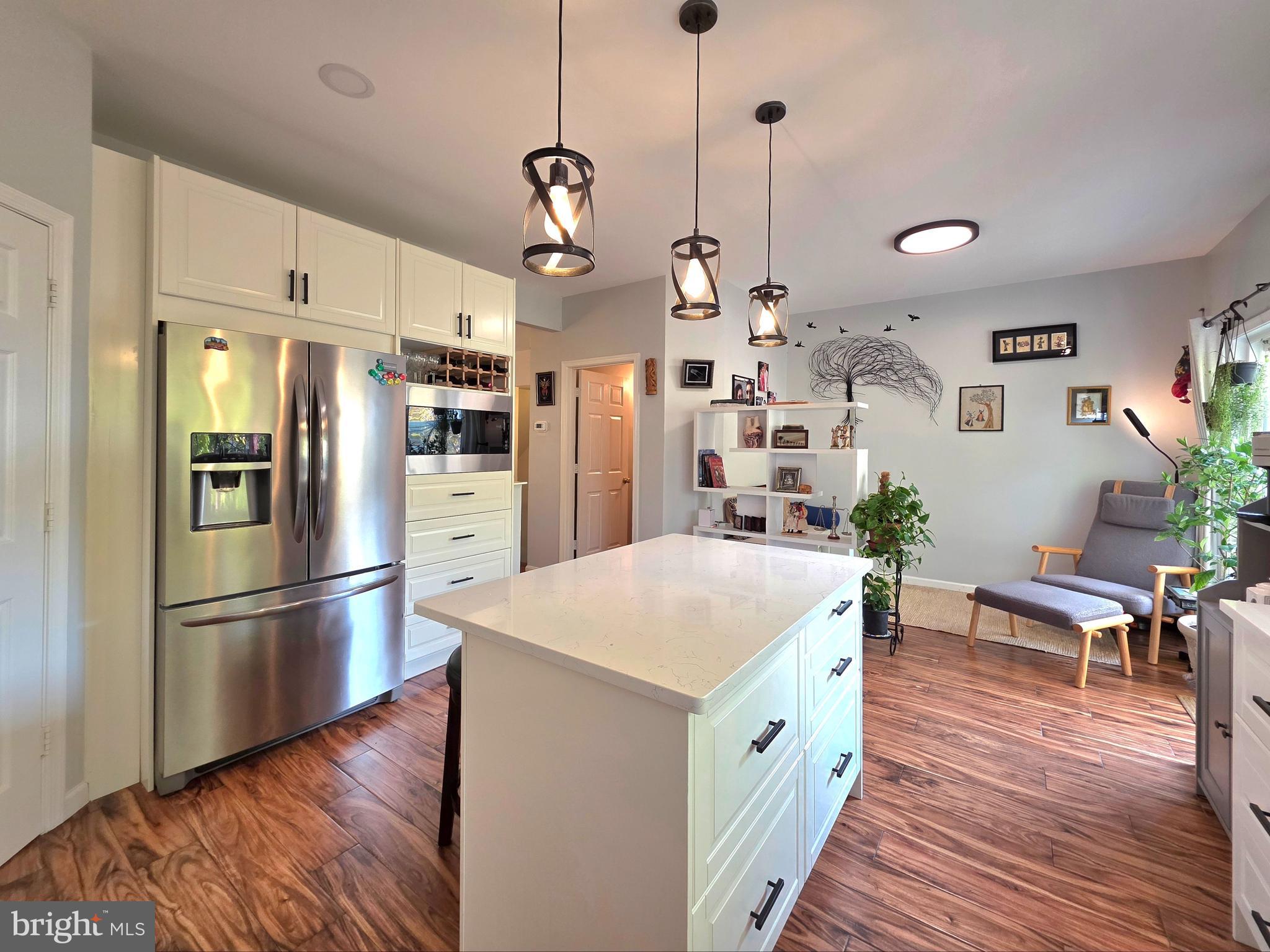2826 Roesh Way Vienna, VA 22181 - Photo 11 of 36 a kitchen with stainless steel appliances granite countertop a refrigerator a sink dishwasher a stove and white cabinets with wooden floor