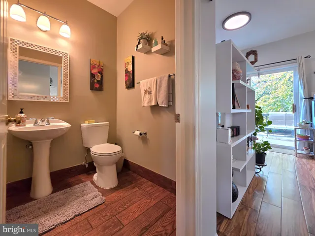 a bathroom with a toilet sink and mirror