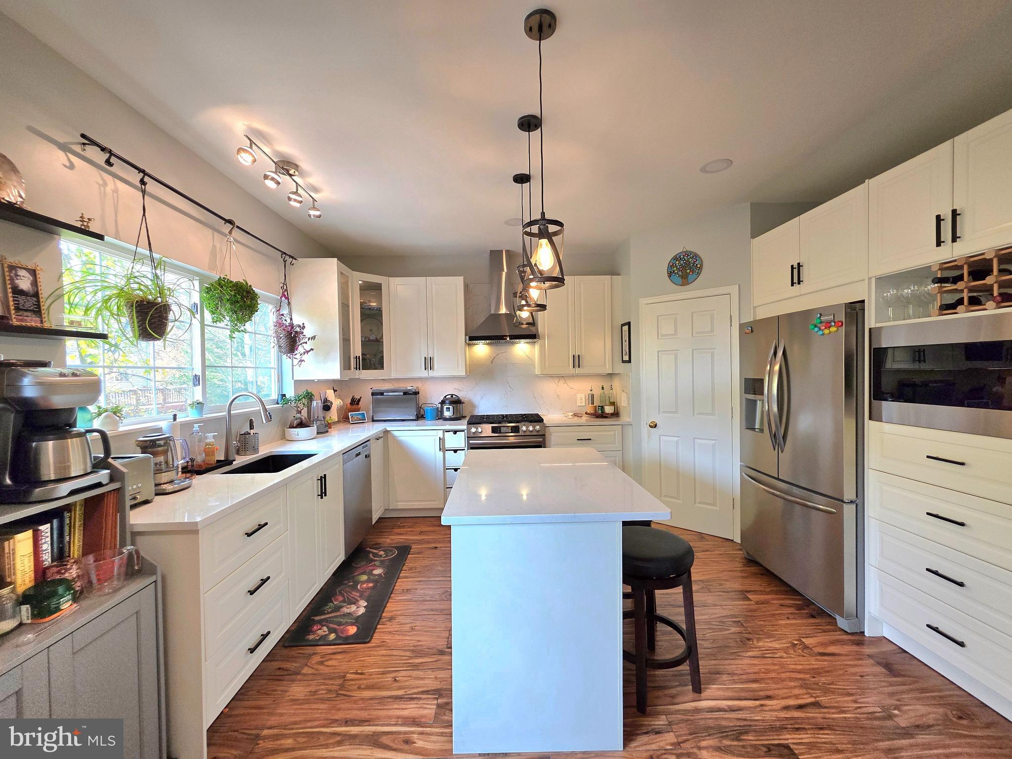 2826 Roesh Way Vienna, VA 22181 - Photo 10 of 36 a kitchen with white cabinets and stainless steel appliances
