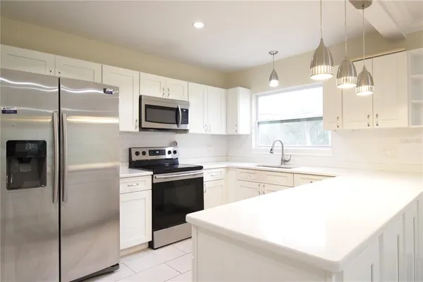 a kitchen with a sink stove and refrigerator