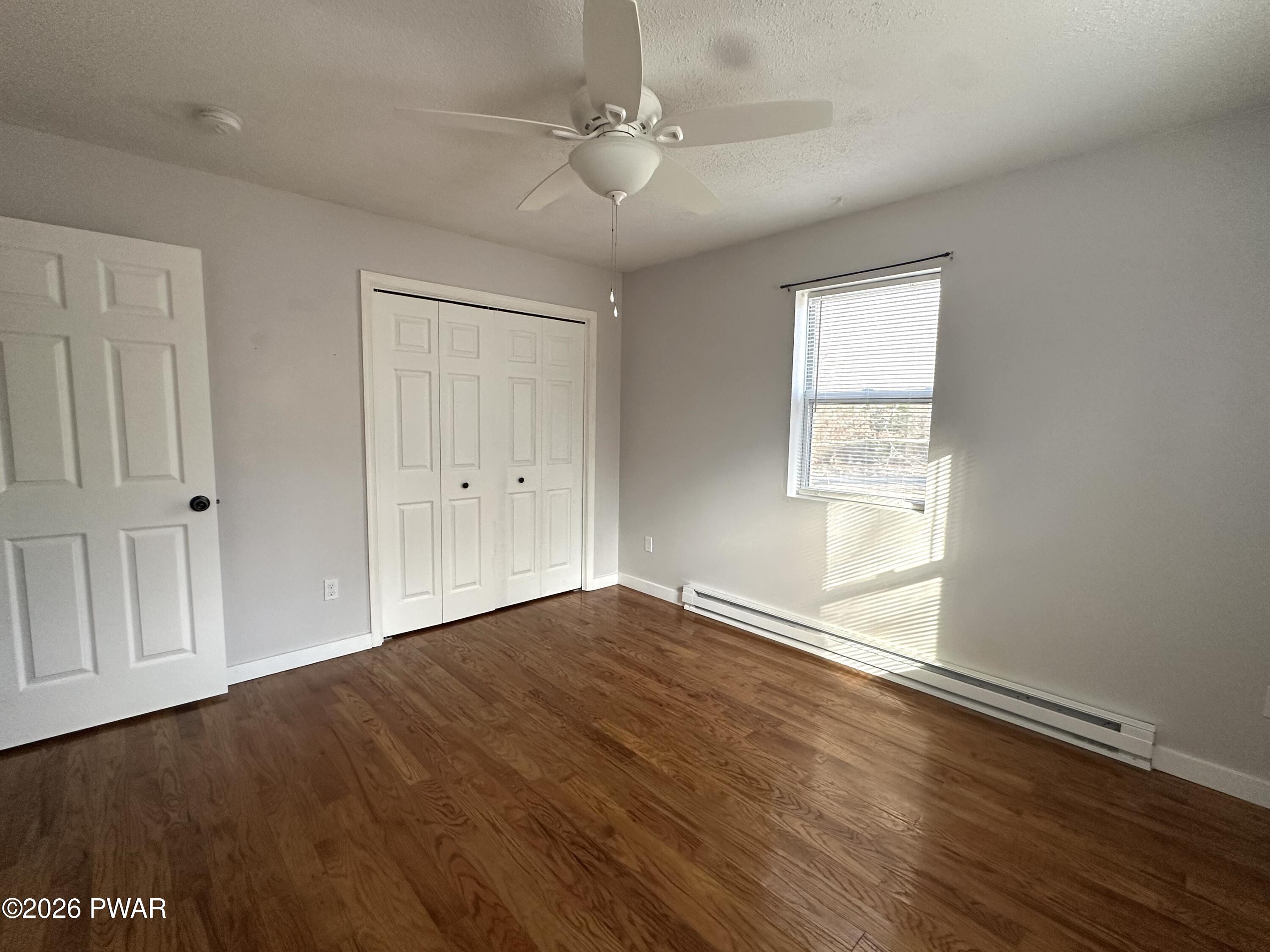 2116 Spring Drive Bushkill, PA 18324 - Photo 9 of 19 wooden floor in an empty room with a window