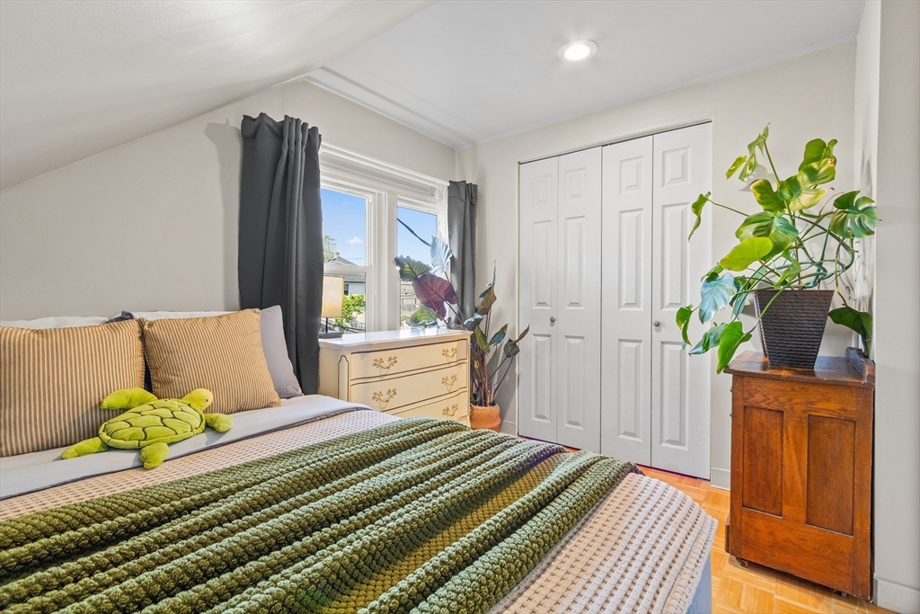 11 Hartlawn Road Boston, MA 02132 - Photo 21 of 34 a bedroom with a bed table and a potted plant