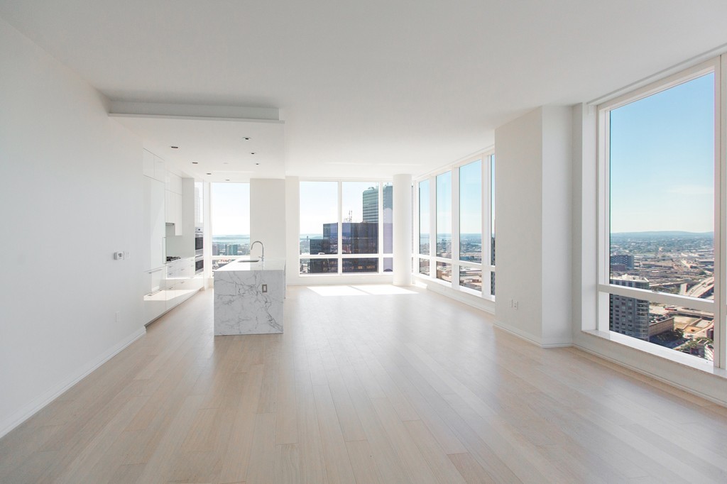 a view of open kitchen with wooden floor and a window