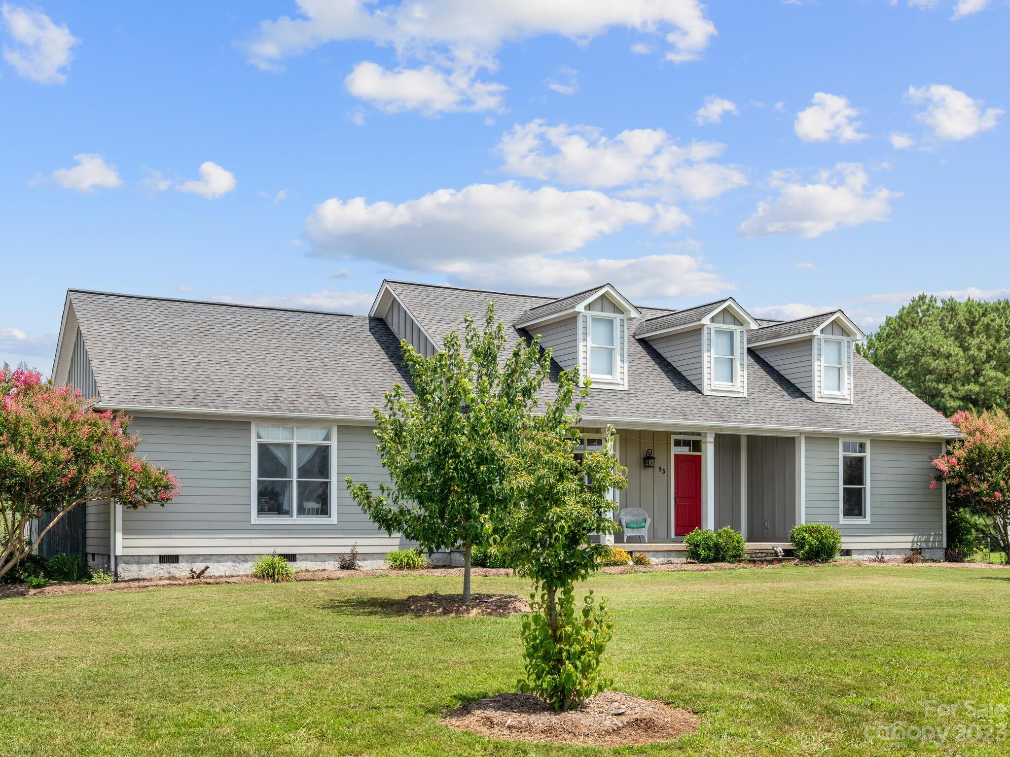 95 Fagan Road Columbus, NC 28722 - Photo 2 of 43 a front view of a house with a garden and plants
