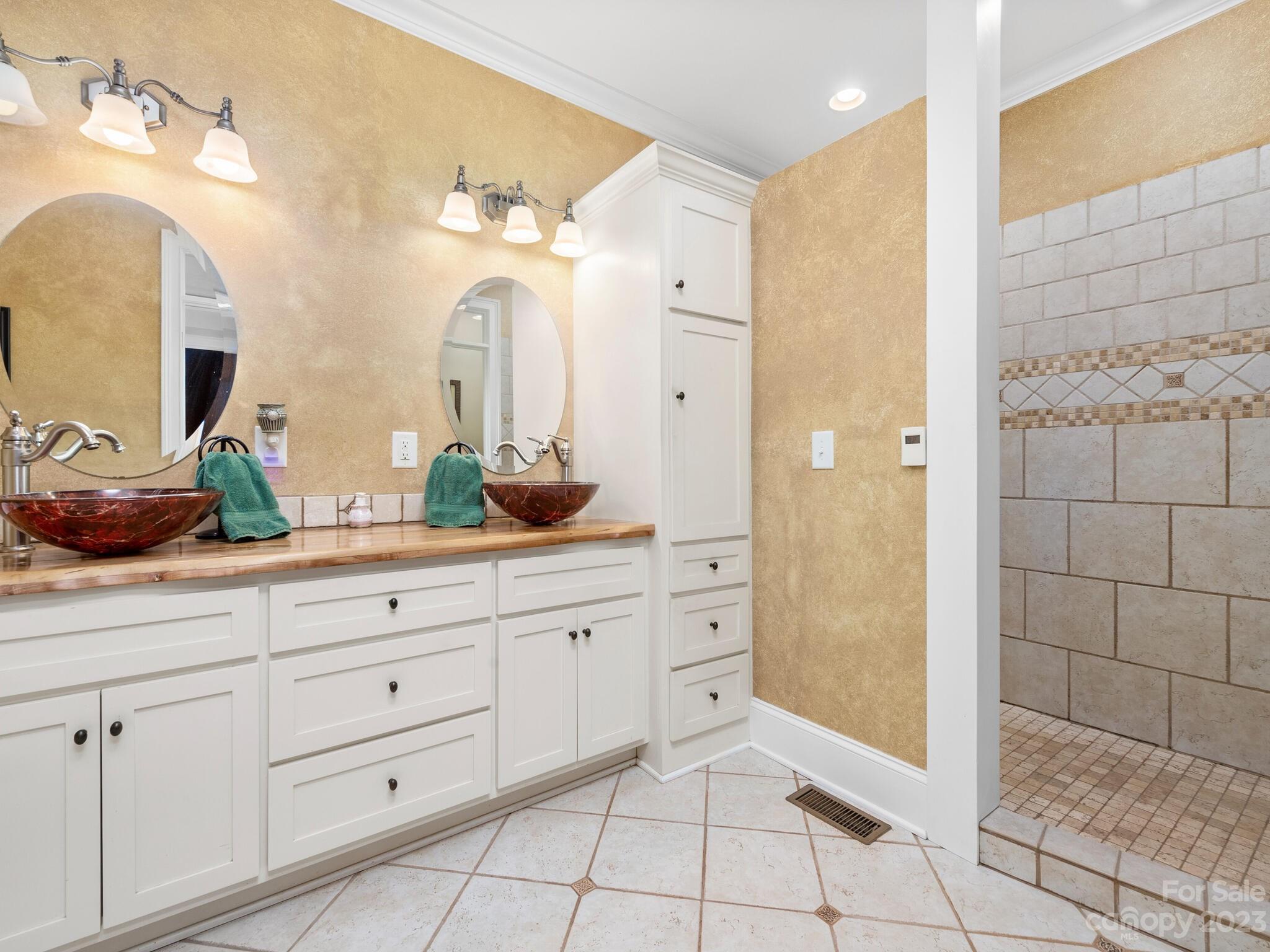 95 Fagan Road Columbus, NC 28722 - Photo 29 of 43 a bathroom with a double vanity sink mirror and shower