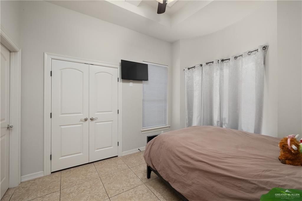 5007 June Court Edinburg, TX 78539 - Photo 11 of 14 a bedroom with a bed and a tv on the dresser