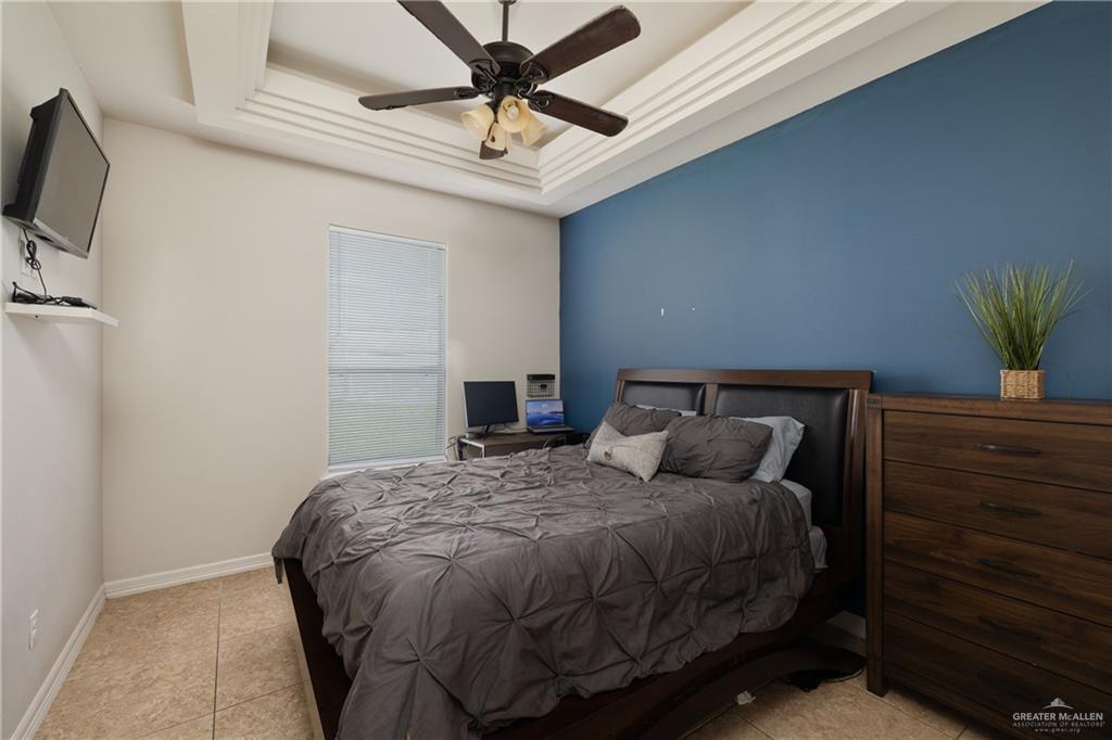 5007 June Court Edinburg, TX 78539 - Photo 12 of 14 a bedroom with a bed and a flat screen tv