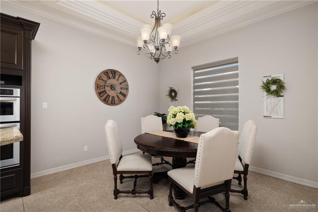 5007 June Court Edinburg, TX 78539 - Photo 5 of 14 a view of a dining room with furniture and a chandelier