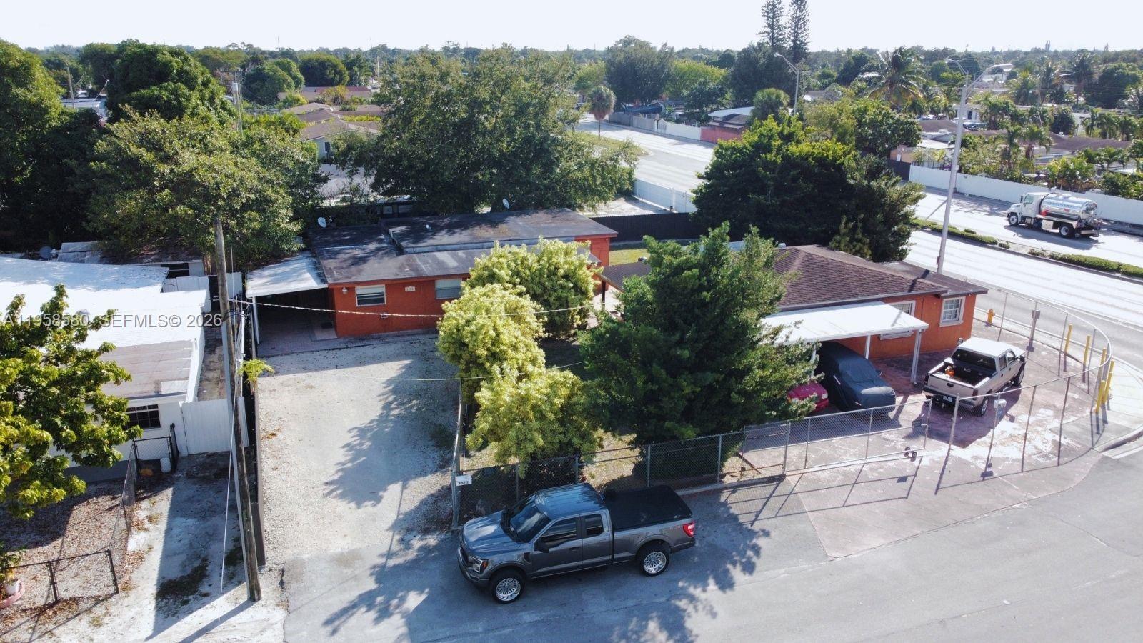3575 Northwest 103rd Street Miami, FL 33147 - Photo 4 of 13 a swimming pool with outdoor seating and plants