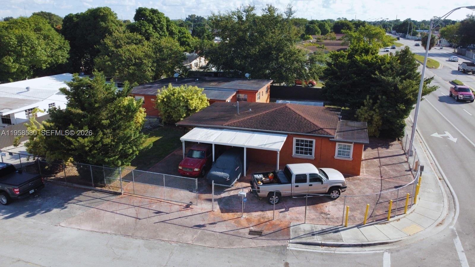 3575 Northwest 103rd Street Miami, FL 33147 - Photo 6 of 13 a front view of a house with garden