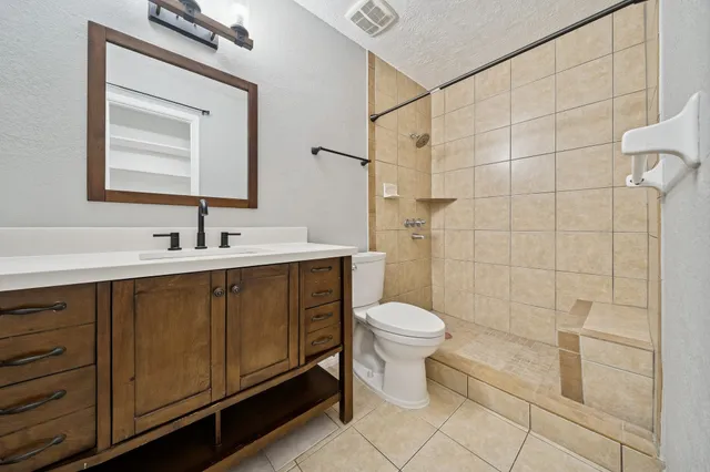 a bathroom with a sink toilet and shower