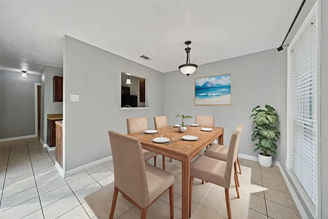 a dining room with furniture and window