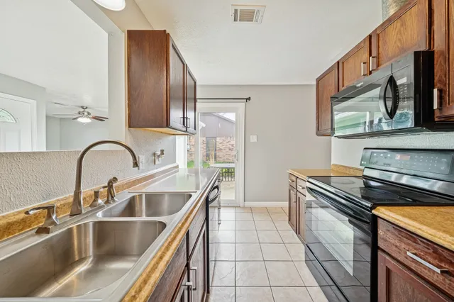a kitchen with a sink and a stove top oven