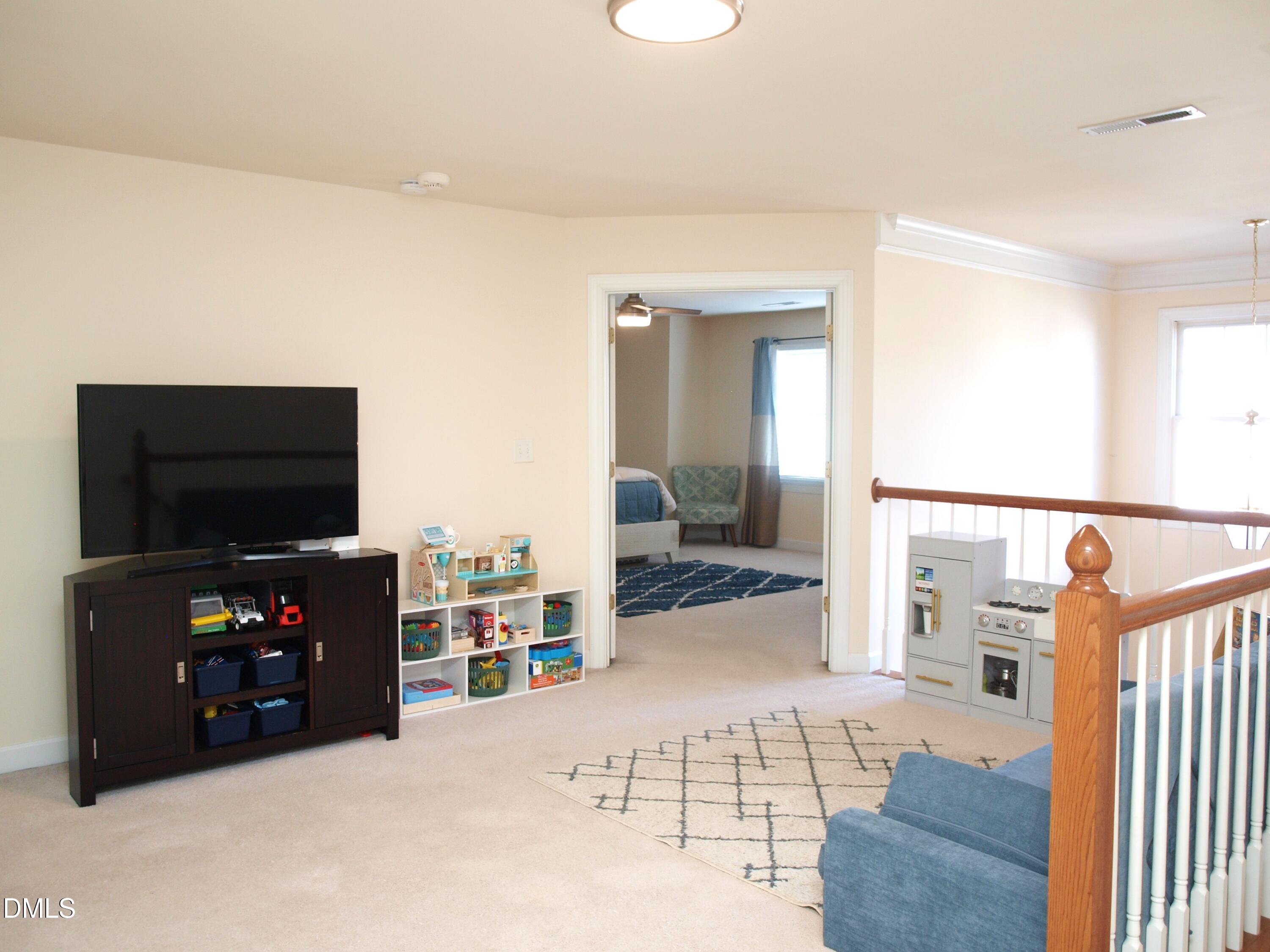 5206 Rio Grande Drive Raleigh, NC 27616 - Photo 29 of 37 a living room with furniture and a flat screen tv