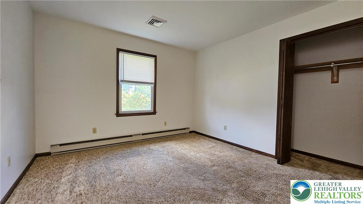 2810 County Line Road Riegelsville, PA 18077 - Photo 3 of 7 A well-lit bedroom features plush carpeting and a convenient walk-in closet.