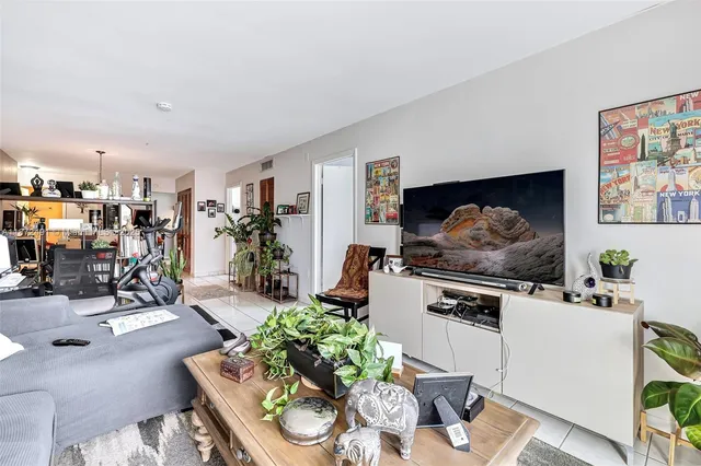 a living room with furniture and a kitchen view