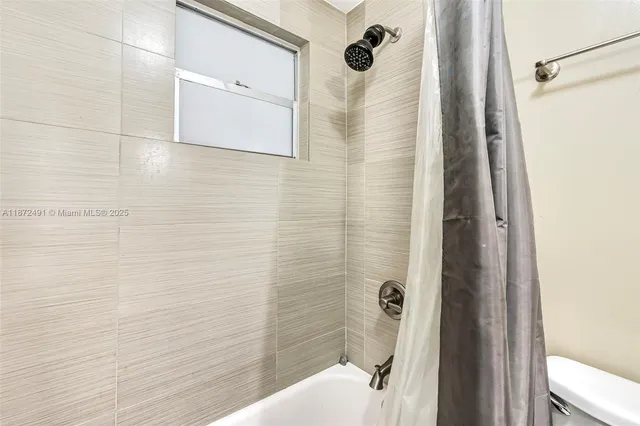 a bathroom with a shower and a toilet