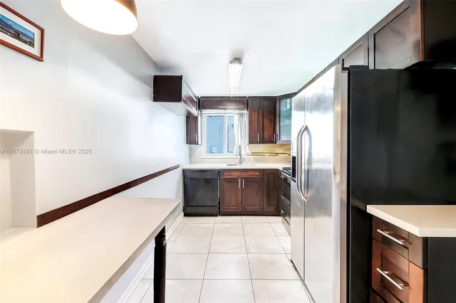 a kitchen with stainless steel appliances a refrigerator and a stove