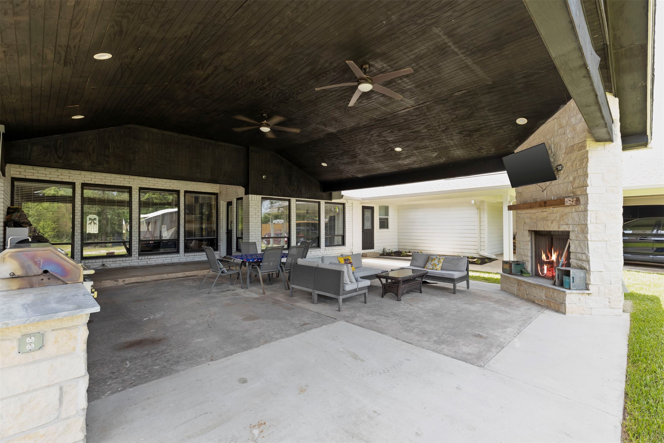18022 Rogers Road New Waverly, TX 77358 - Photo 41 of 49 Covered Patio With Outdoor Grill And Wood Burning Fireplace