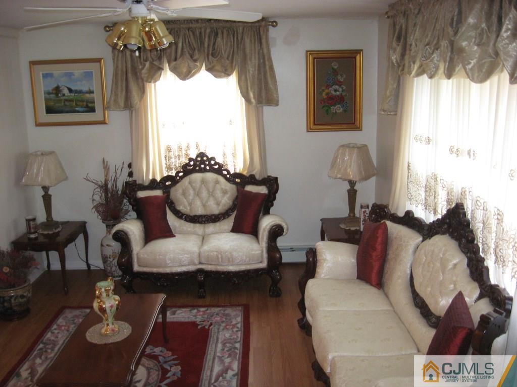 194 Midfield Road Colonia, NJ 07067 - Photo 2 of 25 a living room with furniture and a large window