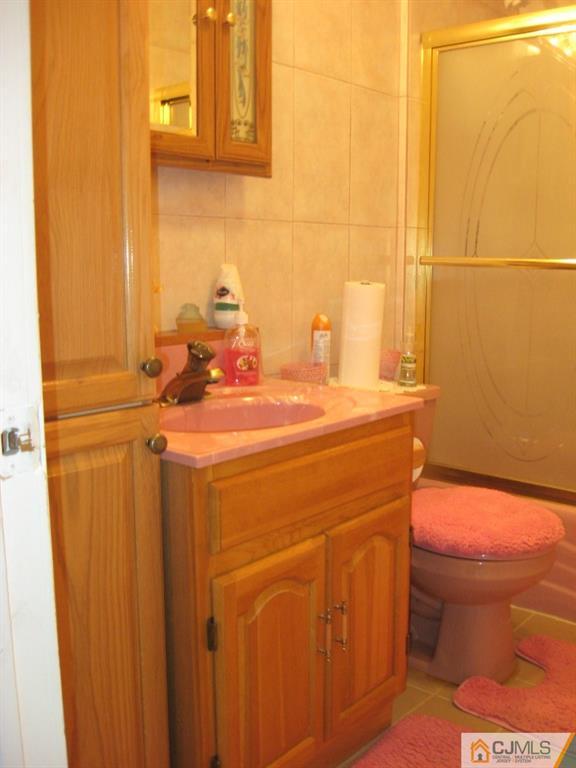 194 Midfield Road Colonia, NJ 07067 - Photo 11 of 25 a bathroom with a sink and a toilet