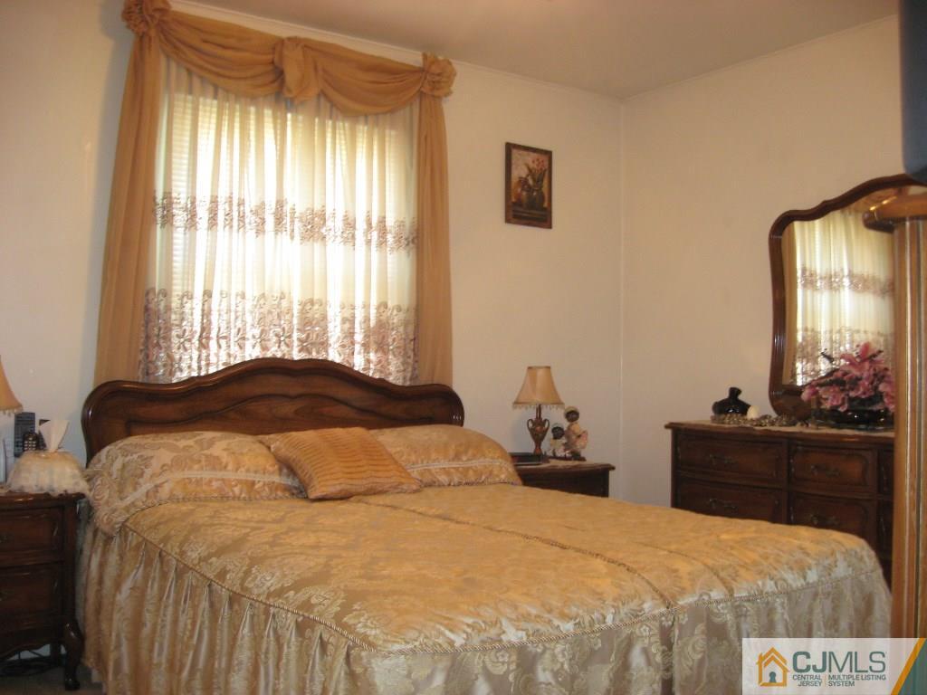 194 Midfield Road Colonia, NJ 07067 - Photo 13 of 25 a bedroom with a bed and a dresser in it