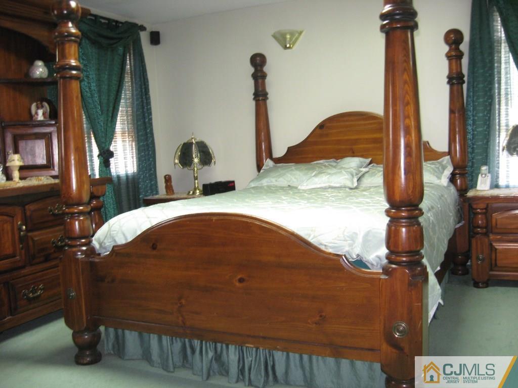 194 Midfield Road Colonia, NJ 07067 - Photo 15 of 25 a bed sitting in a bedroom next to a window