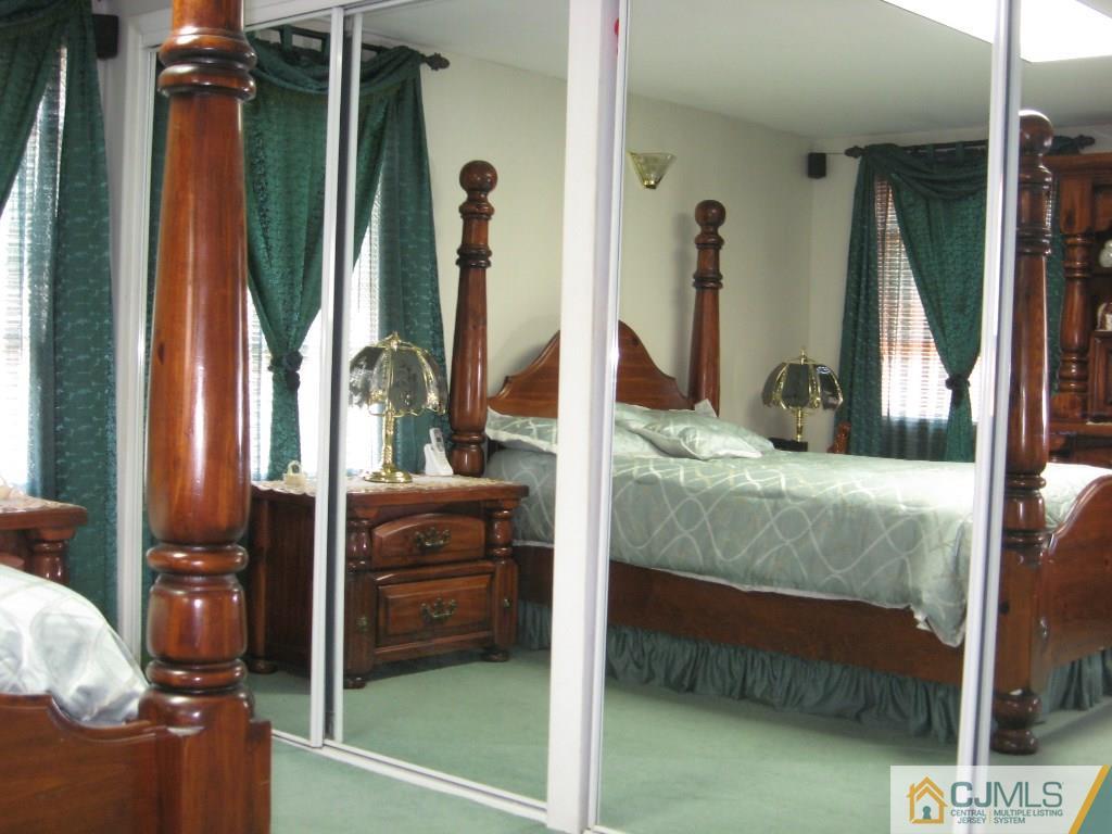 194 Midfield Road Colonia, NJ 07067 - Photo 16 of 25 a bedroom with a bed and a dresser