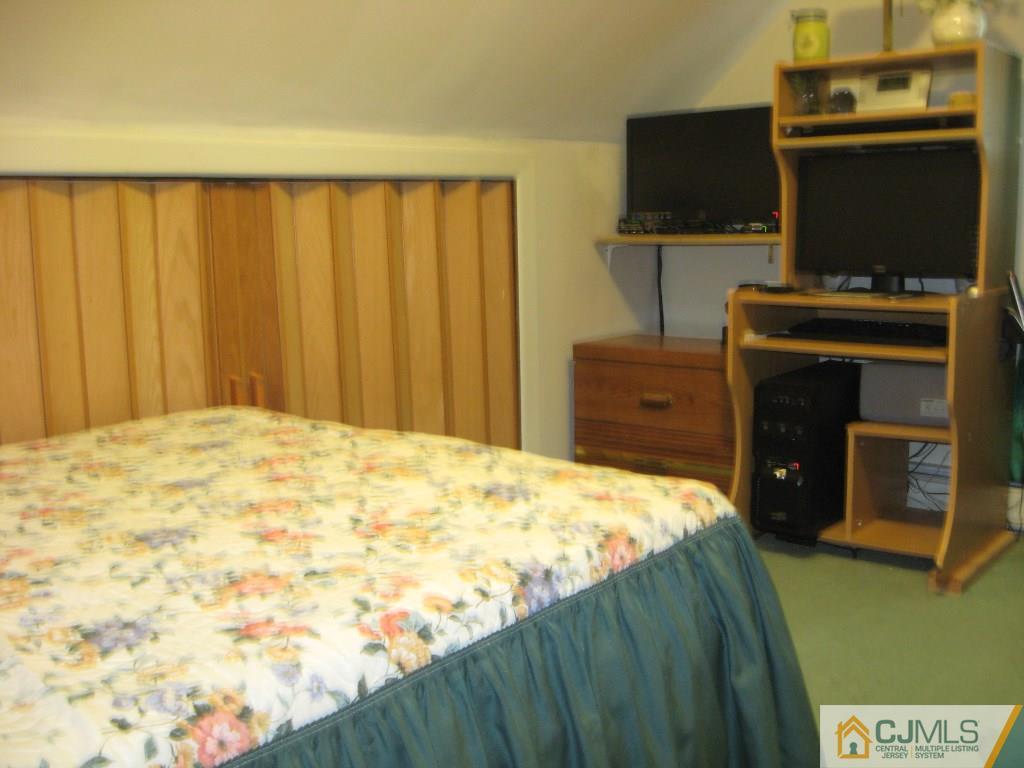 194 Midfield Road Colonia, NJ 07067 - Photo 19 of 25 a bedroom with a bed and flat screen tv