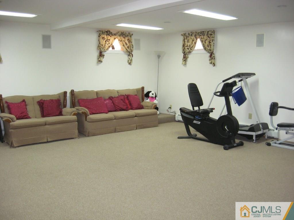 194 Midfield Road Colonia, NJ 07067 - Photo 20 of 25 a living room with furniture and a flat screen tv