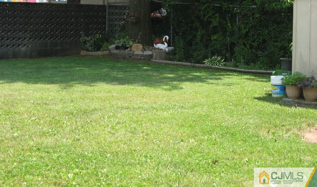 194 Midfield Road Colonia, NJ 07067 - Photo 25 of 25 a backyard of a house with table and chairs