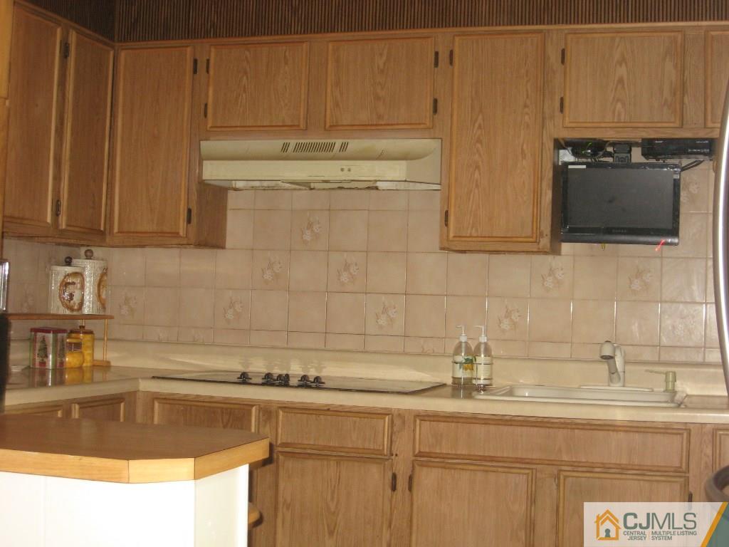 194 Midfield Road Colonia, NJ 07067 - Photo 4 of 25 a kitchen with stainless steel appliances granite countertop a sink and a stove