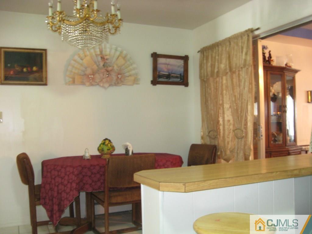 194 Midfield Road Colonia, NJ 07067 - Photo 5 of 25 a view of a dining room with furniture and a chandelier