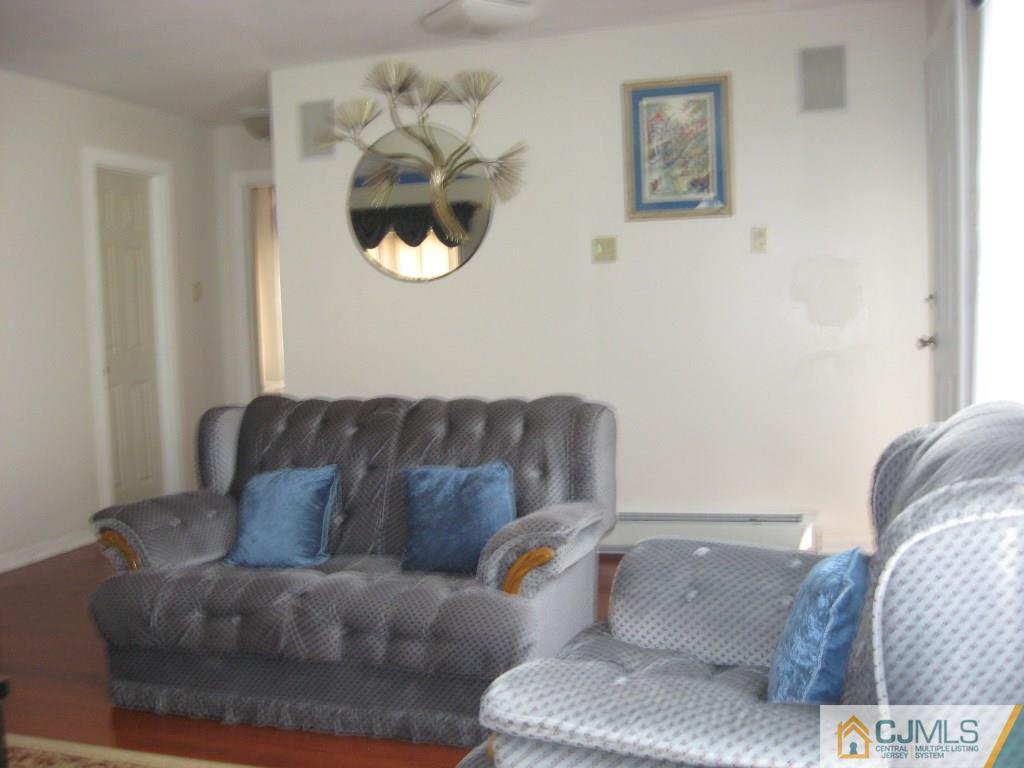 194 Midfield Road Colonia, NJ 07067 - Photo 6 of 25 a living room with a couch and chandelier