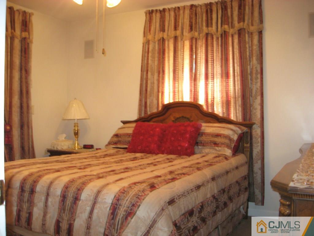 194 Midfield Road Colonia, NJ 07067 - Photo 9 of 25 a bedroom with a bed and a window